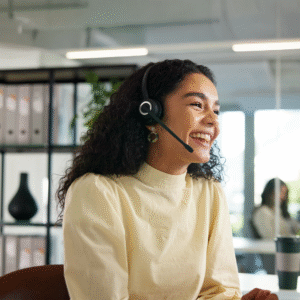 Femme souriante avec casque au bureau.
